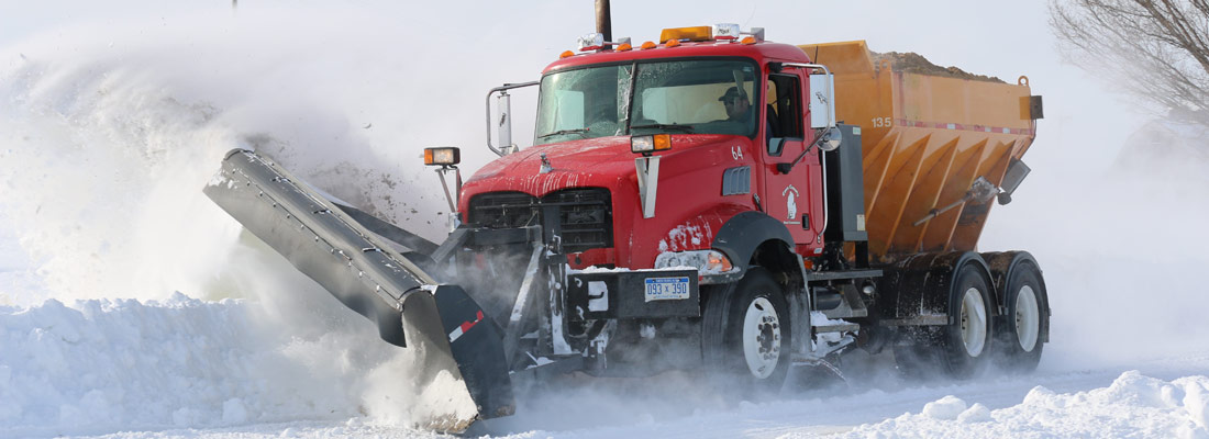 snow plow clearing road in the winter